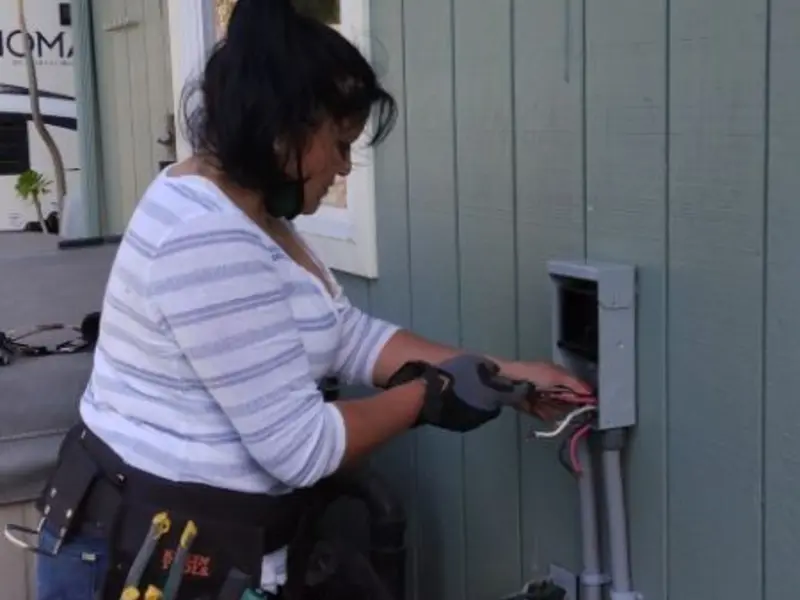 Licensed electrician wiring an exterior subpanel in Oak Park