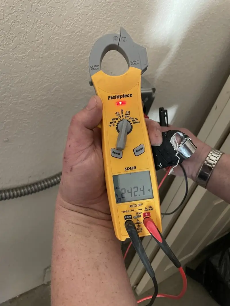 Voltage testing with clamp meter during Outlet Installation in Oak Park